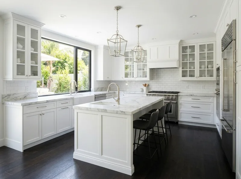 Classic white kitchen with raised-panel cabinets and marble surfaces